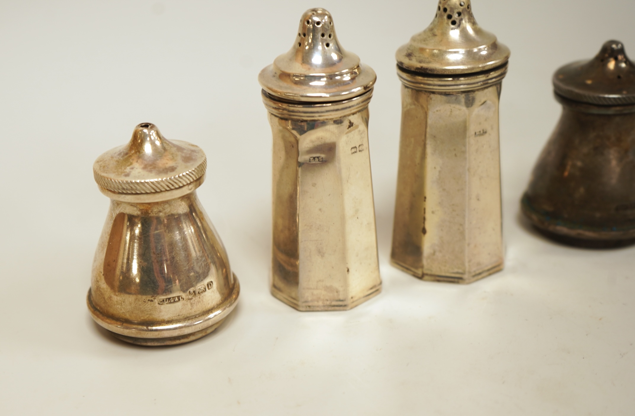 A pair of small George V silver five bar toast racks, Adie Brothers, Birmingham, 1930, length 76mm, together with six assorted silver condiments.